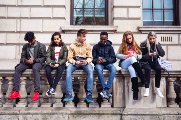 Young Group of People Playing on Their Mobile Devise - Mass Reach